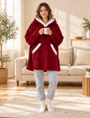 Femme debout avec une tasse portant le pull plaid polaire bordeaux à capuche et poche kangourou